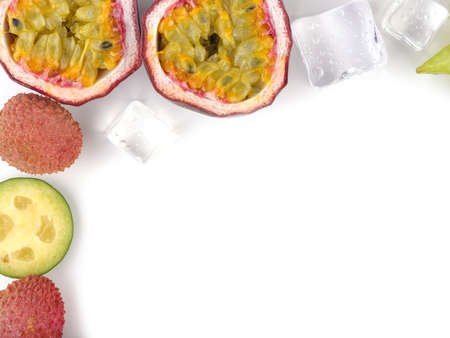 Top view of ripe and tropical slices of fruits with cubes of ice isolated on a white background.の写真素材