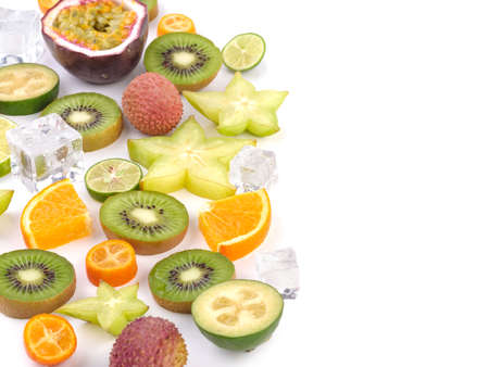 Fresh tropical slices of fruits isolated on white background. Juicy exotic carambolas, lime, litchi, oranges, and mango.の写真素材