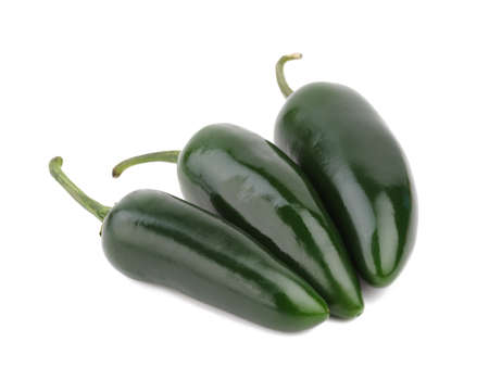 Three bright green peppers isolated on a white background. Organic vegetables full of vitamins concept.の写真素材
