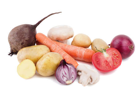 Fresh vegetables isolated on a white background. A composition of young potatoes, mushrooms, carrots, purple onion, tomato and a beet. Summer harvest concept.の写真素材