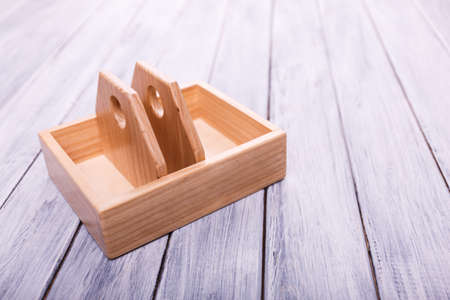 Edicational games for children. Different geometrical figures on the wooden background. Entertaining objects. Copy space. Close-up. Entertainment concept.の写真素材