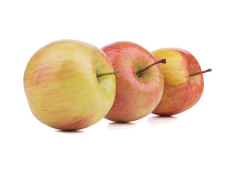 Three juicy, fresh and organic apples isolated on a white background. Healthy fruits full of vitamins.の写真素材