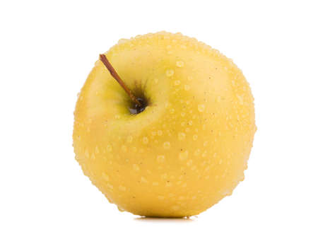 A whole yellow apple isolated on white background. Healthy and organic fruits with vitamins.の写真素材