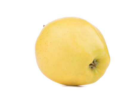 A whole yellow apple isolated on white background. Healthy and organic fruits with vitamins.の写真素材