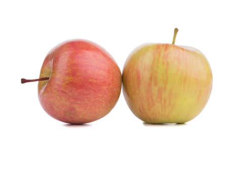 Two whole bright red apples isolated on white background. Healthy fruits. A couple of juicy and organic apples.の写真素材