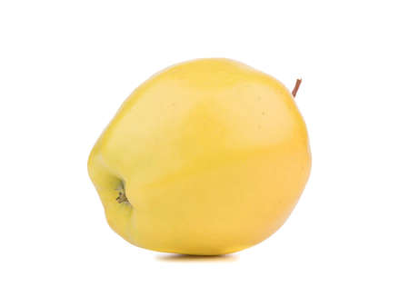 A whole yellow apple isolated on white background. Healthy and organic fruits with vitamins.の写真素材