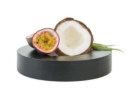 A close-up picture of chopped in half coconut and lime with a flower isolated on white background. The concept of tropical fruits with leaves full of vitamins.の写真素材
