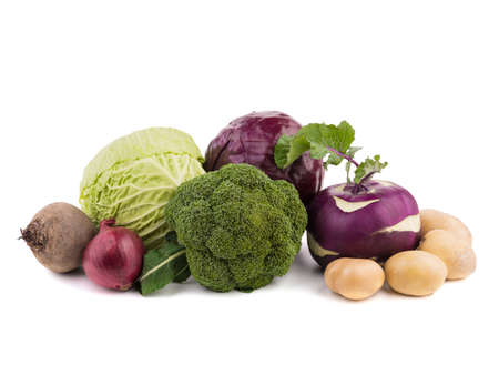Whole heads of cabbage, red onion, beet, turnip, radish, broccoli and potatoes isolated on a white background. A concept of organic vegetablesの写真素材