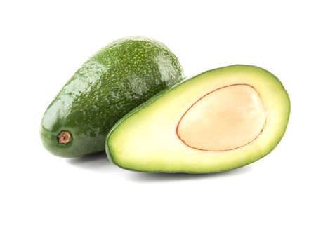 A fresh sliced avocado with stone isolated on white background, close-up. The concept of healthy fruitの写真素材