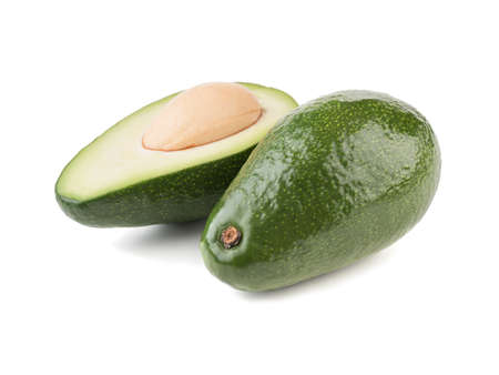 A fresh sliced avocado with stone isolated on white background, close-up. The concept of healthy fruitの写真素材