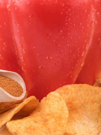 Closeup of crispy potato chips with salt and pepper as a background. Junk food and fast snack concept.の写真素材