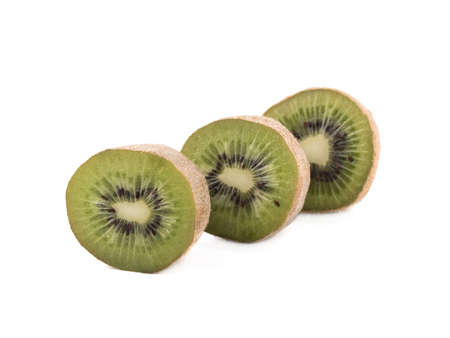 Sliced on halves ripe kiwis isolated on a white background. Hairy brown kiwi with seeds. A concept of exotic fruits full of vitaminsの写真素材