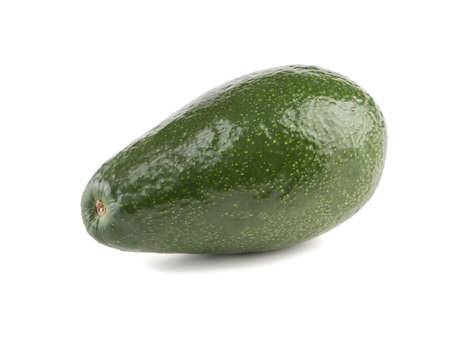 A fresh whole avocado with stone isolated on white background, close-up. The concept of healthy foodの写真素材