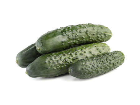 A group of whole cucumbers isolated on white background, close up. The concept of ripe and fresh vegetables.の写真素材