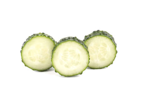 Three pieces of sliced cucumbers isolated on white background, close up. The concept of healthy vegetables.の写真素材