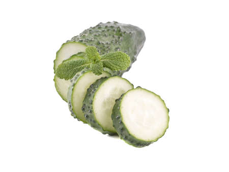 A group of chopped cucumbers isolated on white background, close up. The concept of ripe and fresh vegetables.の写真素材