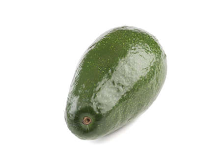 A fresh whole avocado with stone isolated on white background, close-up. The concept of healthy foodの写真素材