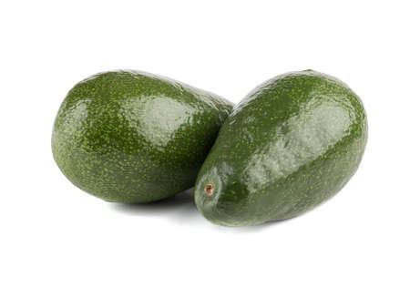 Two big and whole green avocado with stone isolated on white background, close-up. The concept of raw, organic and healthy foodの写真素材
