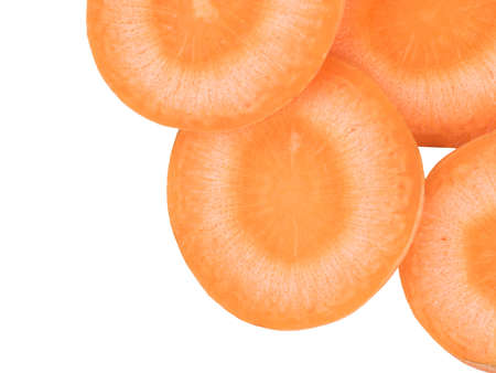 Fresh organic chopped, slices orange carrots isolated on white background, top view. The concept of healthy vegetables.の写真素材