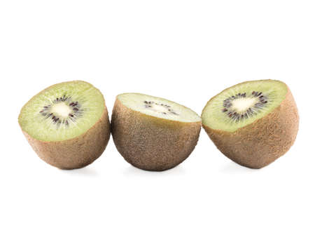 Sliced on halves ripe kiwis isolated on a white background. Hairy brown kiwi with seeds. A concept of exotic fruits full of vitaminsの写真素材