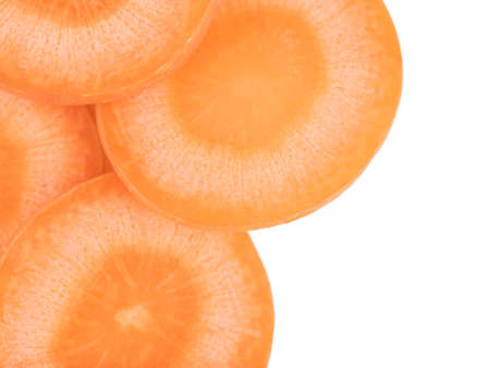 Fresh organic chopped, slices orange carrots isolated on white background, top view. The concept of healthy vegetables.の写真素材