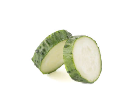 Two pieces of sliced cucumbers isolated on white background, close up. The concept of healthy vegetables.の写真素材