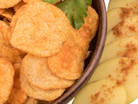 Closeup of crispy potato chips with salt and pepper as a background. Junk food and fast snack concept.の写真素材