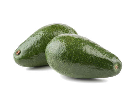 Two big and whole green avocado with stone isolated on white background, close-up. The concept of...