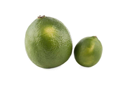 Two green whole varietal lime isolated on white background. A concept of citrus fruits full of vitaminsの写真素材