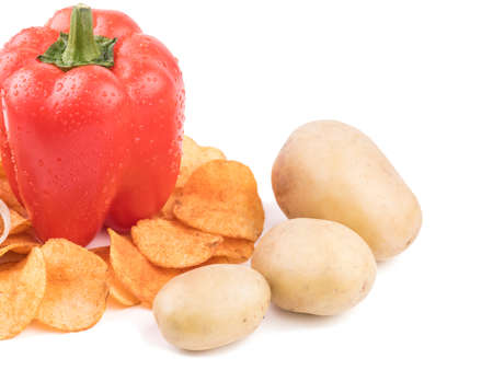 Crispy potato chips with spices, pepper, potatoes isolated on a white background. Junk food concept. Close-up of a fast snack.の写真素材