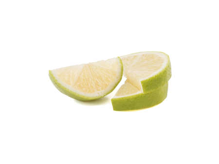 Green slices of ripe and fresh lime isolated on white background. A concept of citrus fruits full of vitaminsの写真素材