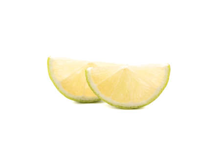 Green slices of ripe and fresh lime isolated on white background. A concept of citrus fruits full of vitaminsの写真素材