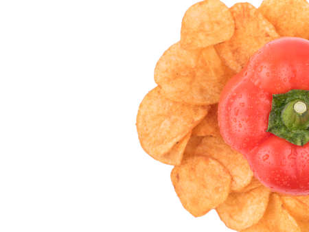 Top view of crispy potato chips with spices from red pepper isolated on a white background. Junk food concept. Close-up of a fast snack.の写真素材