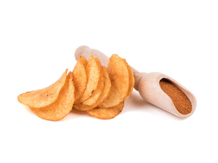 Crispy potato chips with spices from pepper isolated on a white background. Junk food concept. Close-up of a fast snack.の写真素材