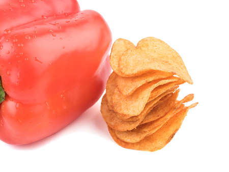 Crispy potato chips with spices from red pepper isolated on a white background. Junk food concept. Close-up of a fast snack.の写真素材