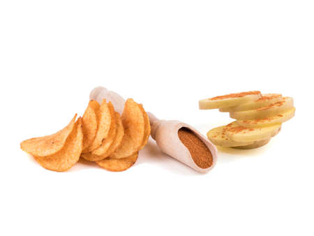 Crispy potato chips with spices from pepper isolated on a white background. Junk food concept. Close-up of a fast snack.の写真素材