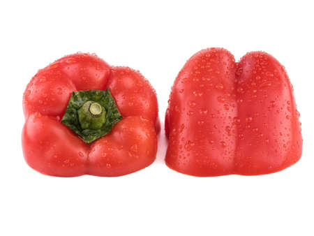 A red pepper cut in half isolated on a white background. Healthy and organic vegetable with vitamins.の写真素材