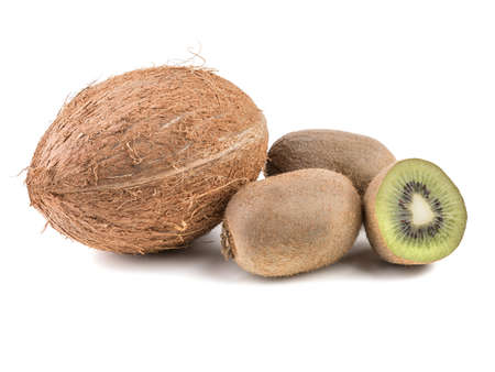 Sliced on halves and whole ripe kiwis and a whole coconut isolated on a white background. A concept of exotic fruits full of vitaminsの写真素材
