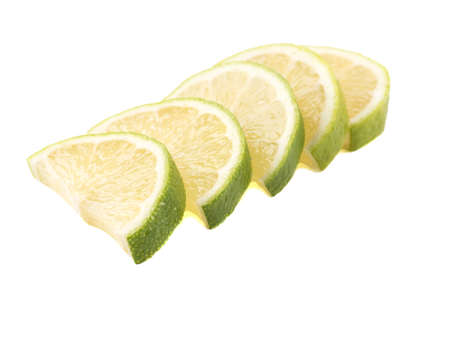 Green slices of ripe and fresh lime isolated on white background. A concept of citrus fruits full of vitaminsの写真素材