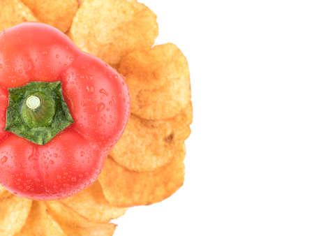 Top view of crispy potato chips with spices from red pepper isolated on a white background. Junk food concept. Close-up of a fast snack.の写真素材