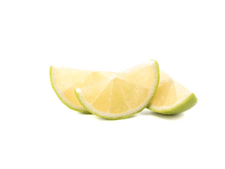Green slices of ripe and fresh lime isolated on white background. A concept of citrus fruits full of vitaminsの写真素材