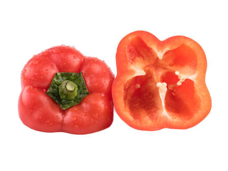 A red pepper cut in half isolated on a white background. Healthy and organic vegetable with vitamins.の写真素材