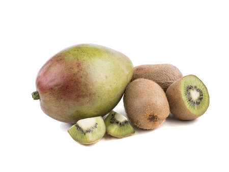 Sliced on halves and whole ripe kiwis and a whole mango isolated on a white background. A concept of exotic fruits full of vitaminsの写真素材