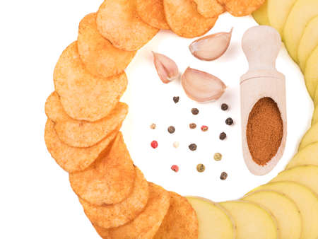 Crispy potato chips with spices from pepper isolated on a white background. Junk food concept. Close-up of a fast snack.の写真素材