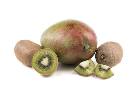 Sliced on halves and whole ripe kiwis and a whole mango isolated on a white background. A concept of exotic fruits full of vitaminsの写真素材