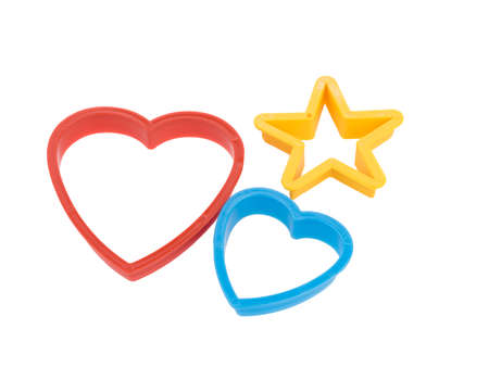 Close-up of colorful cookie cutters isolated on a white background. Gingerbread and pastry cutters in star, heart, man form.の写真素材