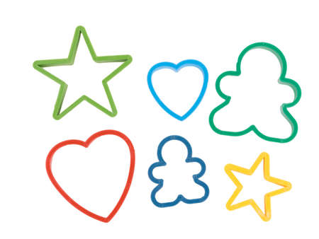Close-up of colorful cookie cutters isolated on a white background. Gingerbread and pastry cutters in star, heart, man form.の写真素材