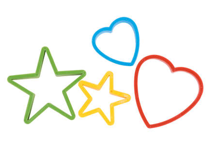 Close-up of colorful cookie cutters isolated on a white background. Gingerbread and pastry cutters in star, heart, man form.の写真素材