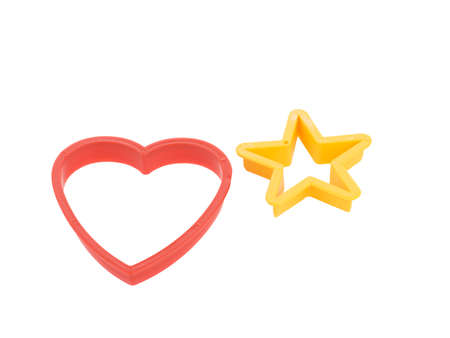 Close-up of colorful cookie cutters isolated on a white background. Gingerbread and pastry cutters in star, heart, man form.の写真素材