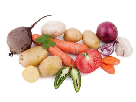 Fresh and organic vegetables isolated on a white background. Tomatoes, onions, mushrooms, potatoes, pepper, cabbage, beetroot and parsley for salad.の写真素材